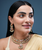 Woman wearing traditional multicolor kundan choker necklace set with matching earrings and pearl bead detailing.