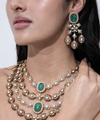 Luxury wedding jewelry set with emerald green stones, sparkling Moissanite detailing, and matching earrings.