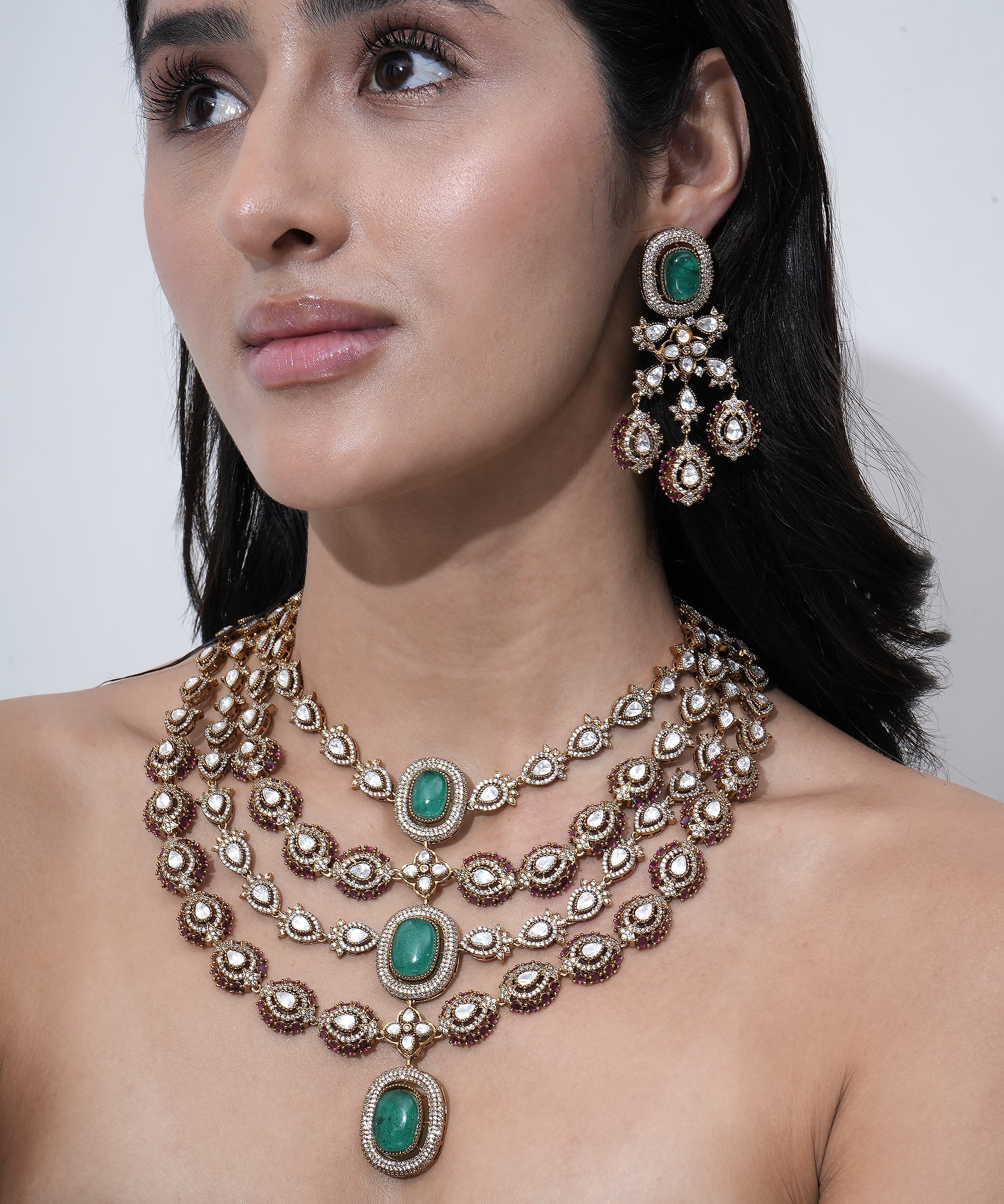 Designer layered necklace set for women with green gemstones, Moissanite stones, and traditional craftsmanship.