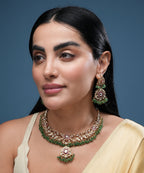 Designer ethnic choker jewelry set for women with kundan stones, green bead drops, and statement earrings.