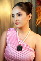 Handmade freshwater pearl necklace with black Buddha head pendant and crystal detailing – unisex spiritual jewellery.”