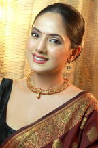 “Antique gold filigree choker necklace set with pearl drop pendant and matching earrings – traditional Indian jewellery.”