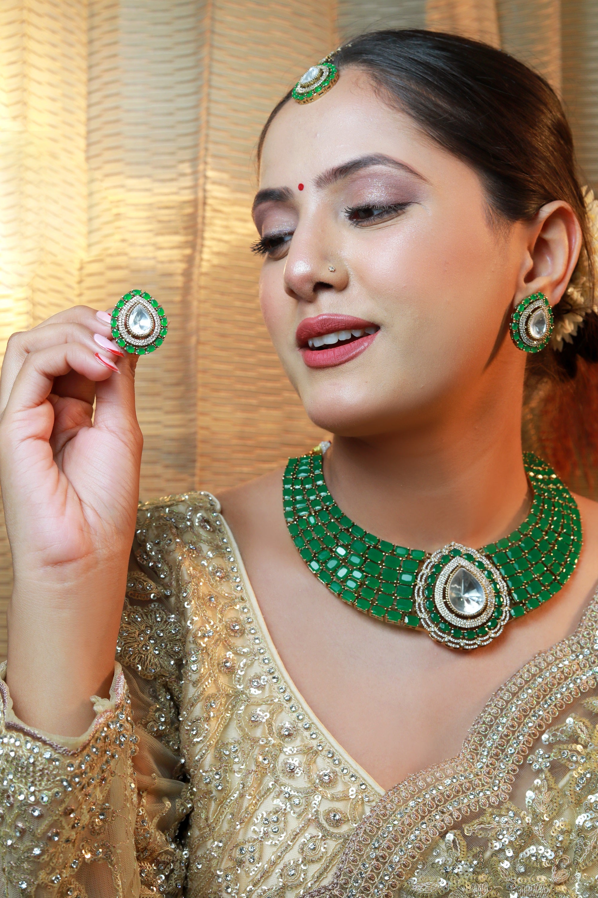 “Emerald green statement choker necklace with rectangular stones and a large pear-shaped polki centerpiece.”