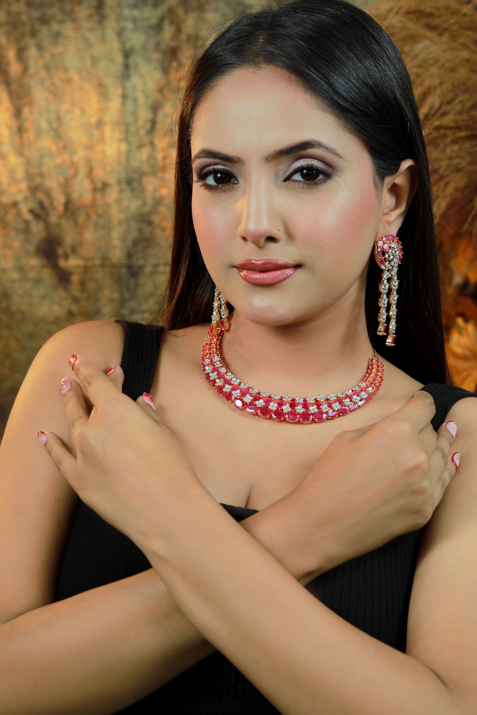 “Gold-plated triple-layer ruby necklace set with CZ floral stones and matching long earrings.”