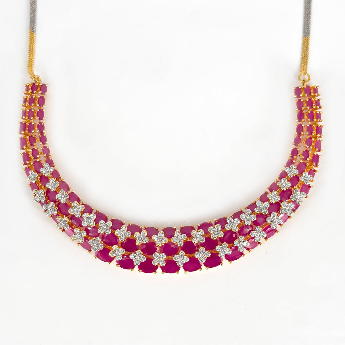 “Gold-plated triple-layer ruby necklace set with CZ floral stones and matching long earrings.”