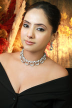 “Silver American Diamond necklace set with matching earrings featuring round and baguette CZ stones in loop design”