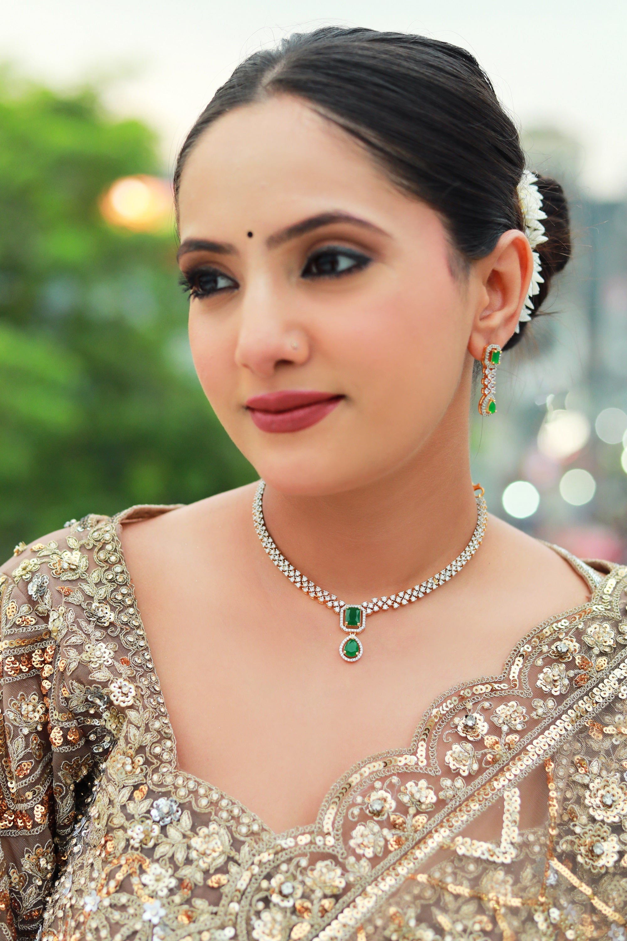 “Emerald green pendant necklace set with diamond CZ stones and matching earrings – Damani Jewels.”