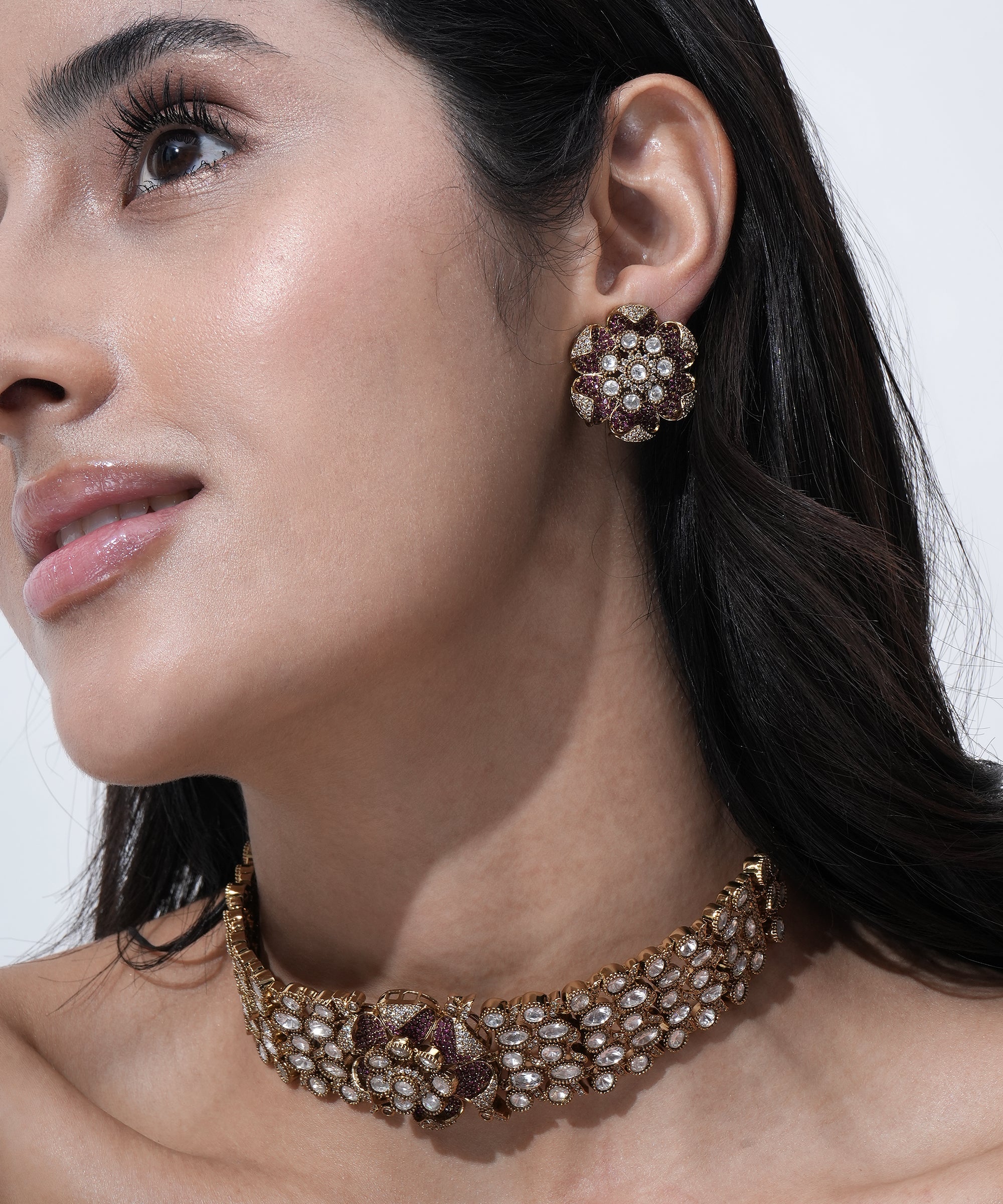 Designer Moissanite choker necklace featuring floral motifs, sparkling white stones, pink accents, and matching stud earrings.