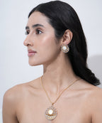 Designer coin-inspired pendant with matching statement earrings