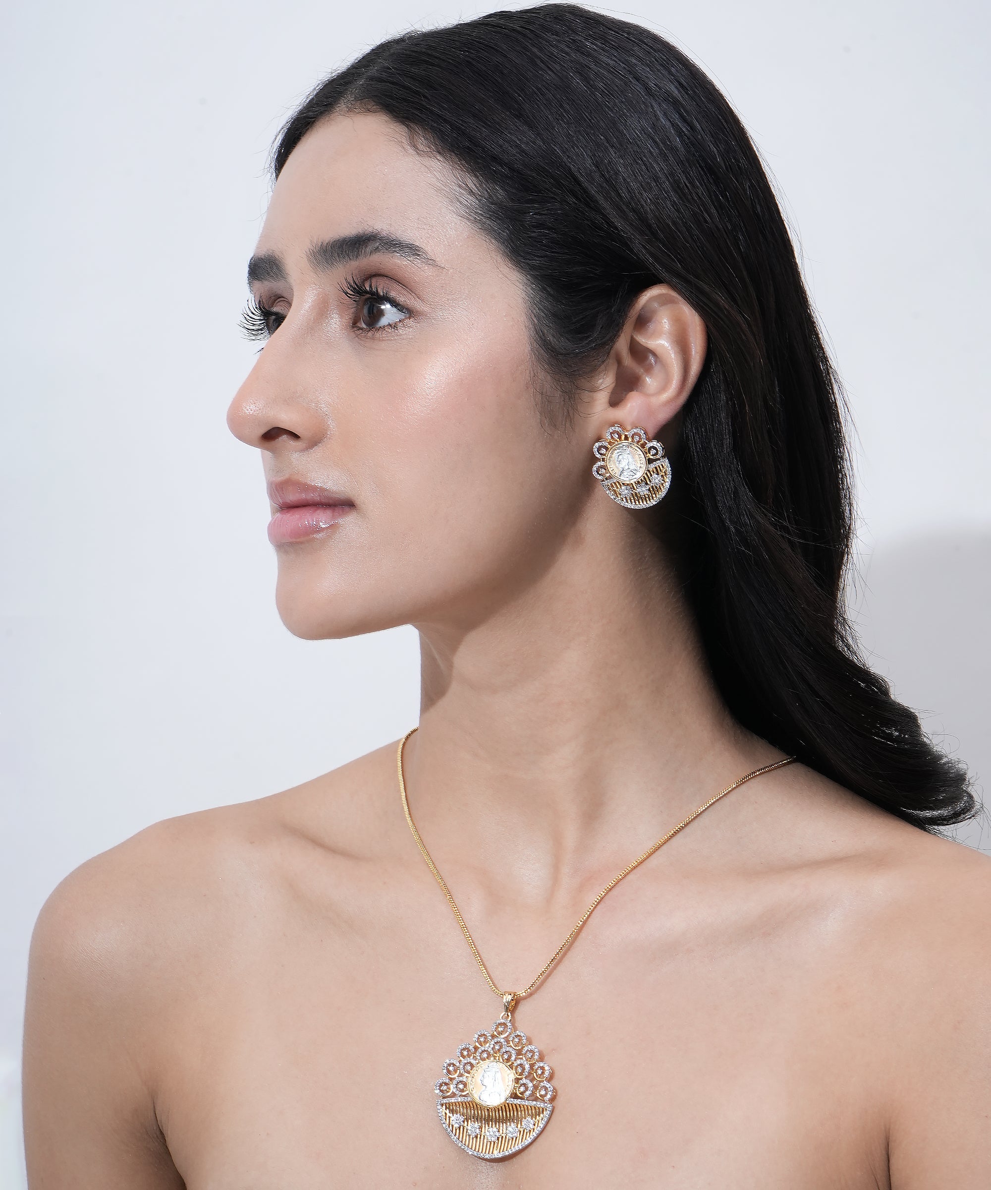 Designer coin-inspired pendant with matching statement earrings