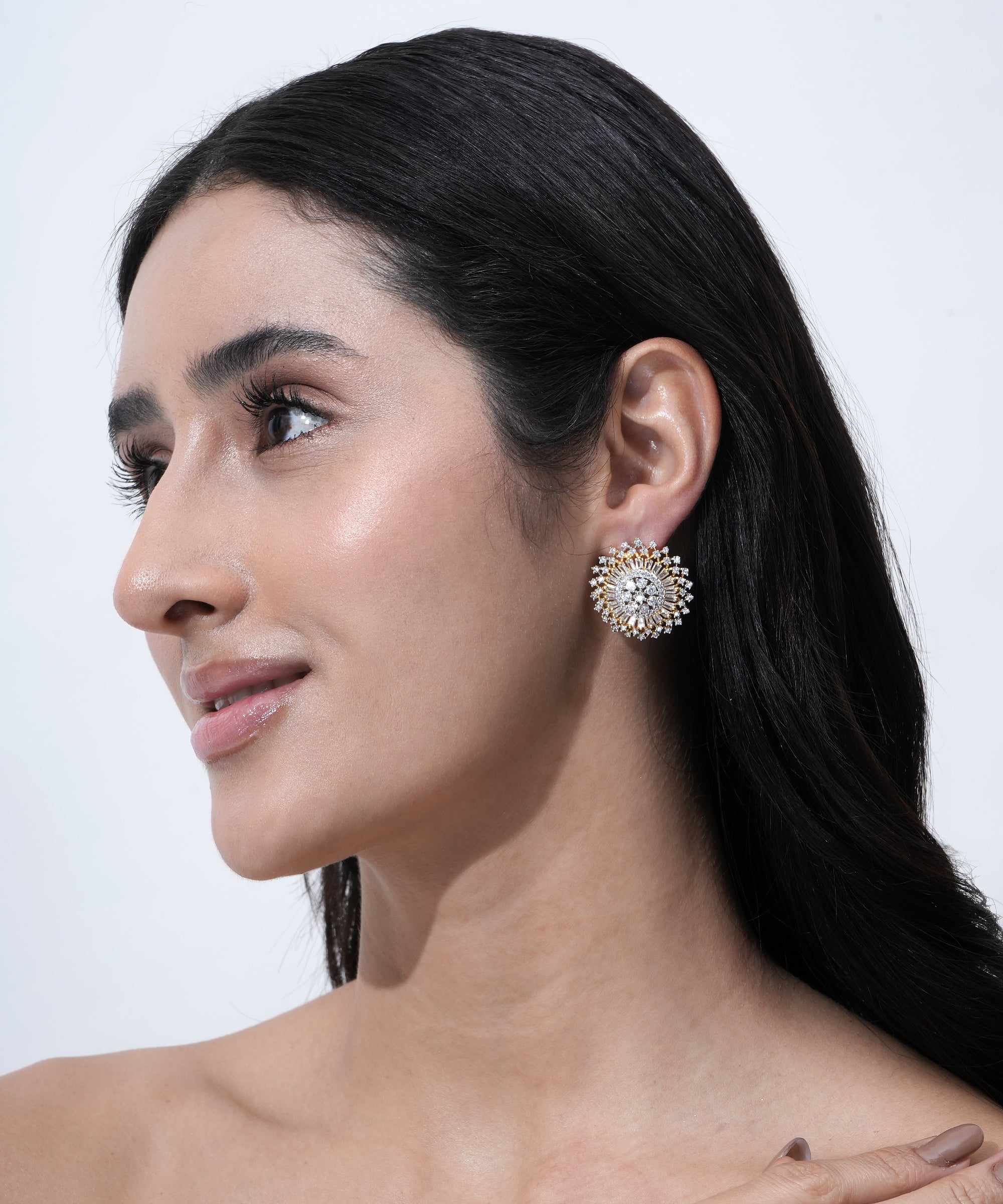 Designer gold-tone stud earrings with dazzling crystal detailing for party and wedding wear.