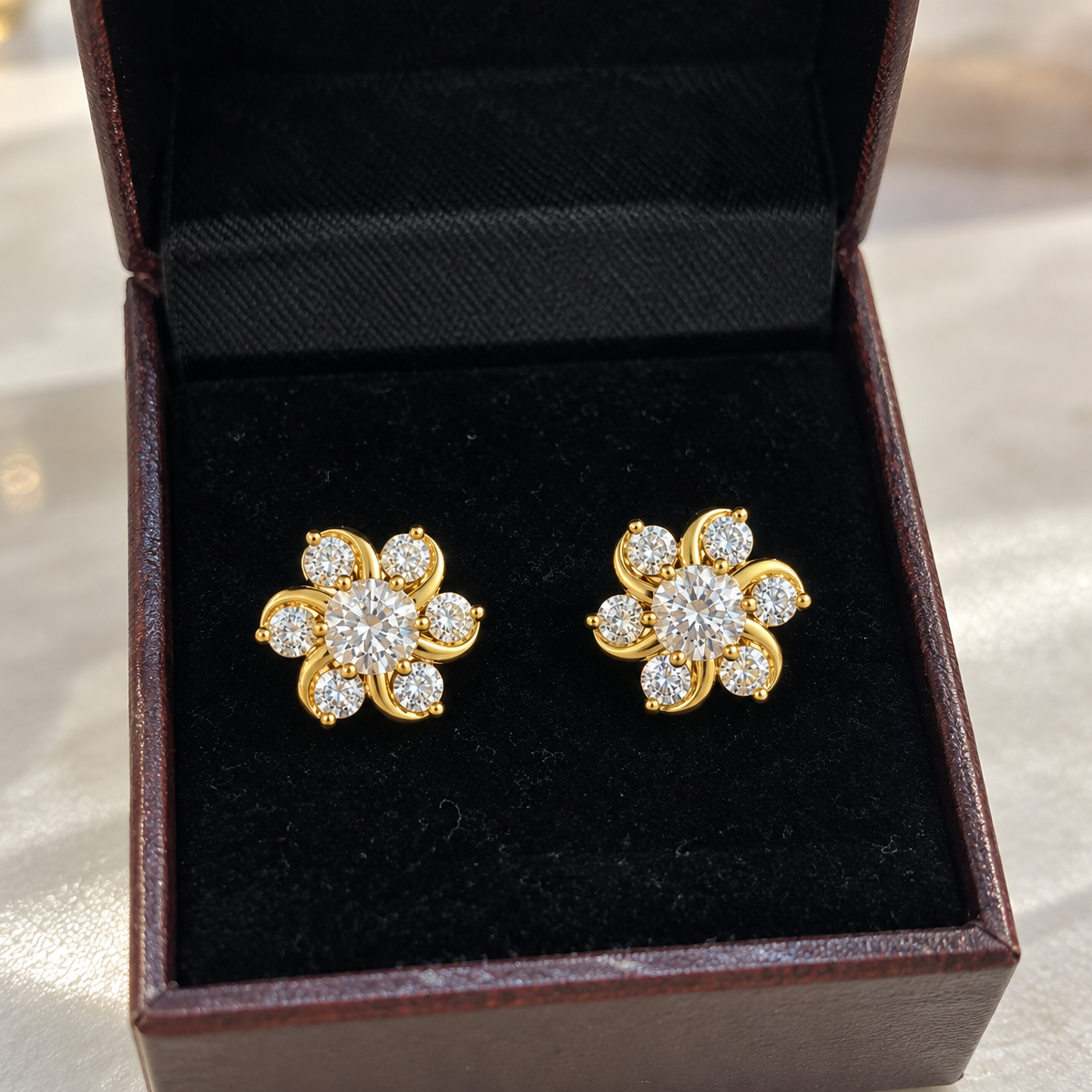 Gold tone floral crystal stud earrings with sparkling center stone