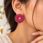 Woman wearing pink ruby floral statement earrings