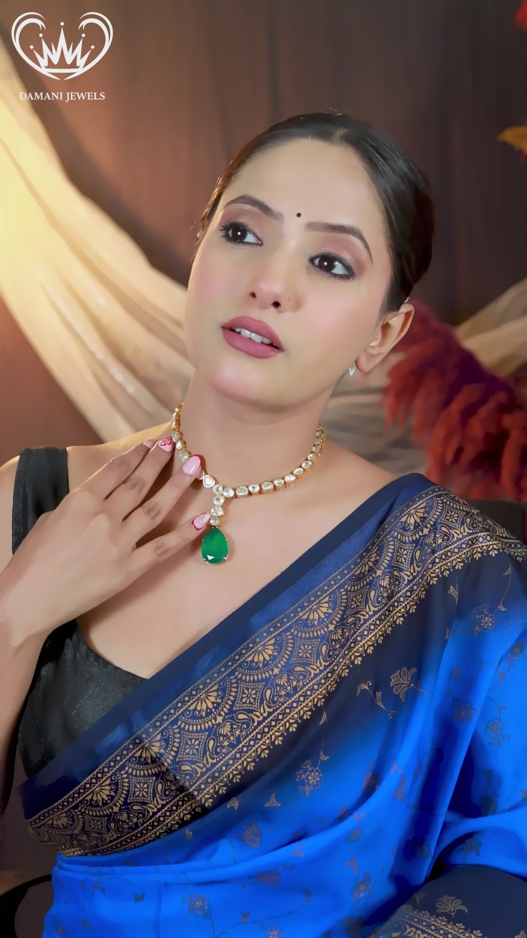 “Model wearing an emerald green teardrop kundan necklace with matching earrings — Damani Jewels.”