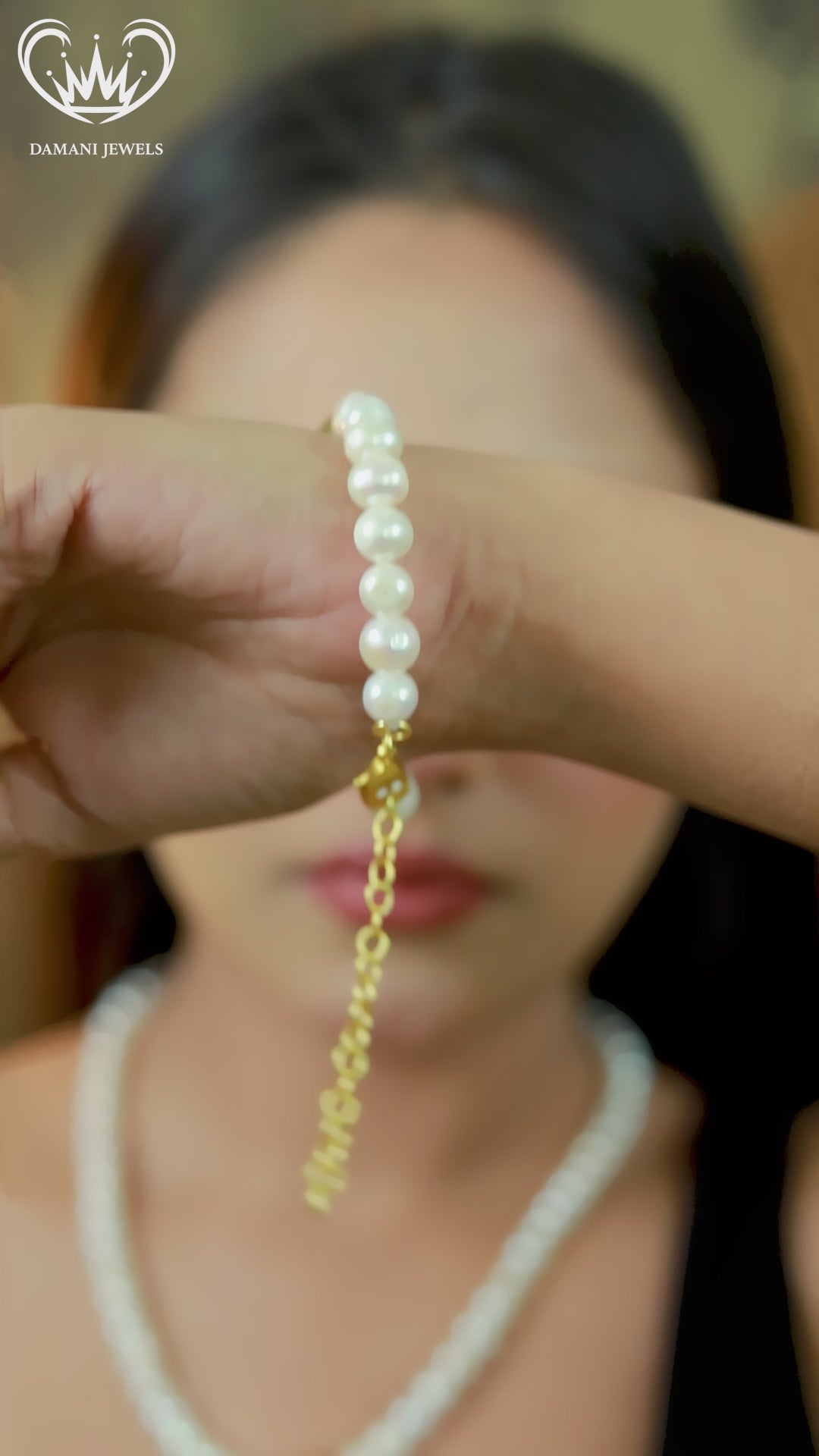 Woman wearing white pearl necklace and matching bracelet with gold accent bead.
